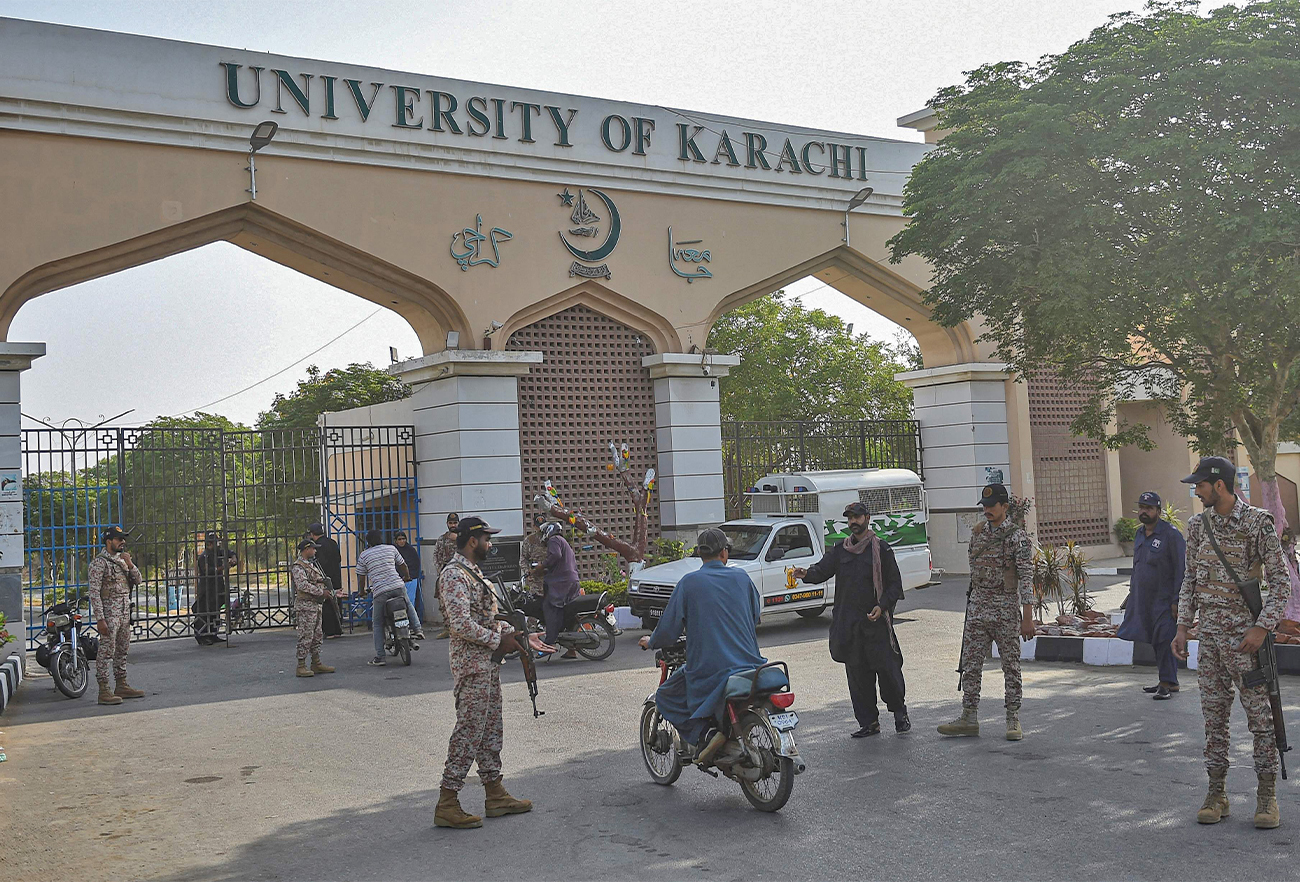 Rangers check motorcyclists at a security checkpoint set up near a university gate in Karachi on April 27, 2022. (AFP)