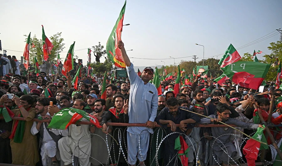 Supporters of ruling Pakistan Tehreek-e-Insaf (PTI) party attend a rally being addressed by Pakistan's Prime Minister Imran Khan, in Islamabad on March 27, 2022. (AFP)