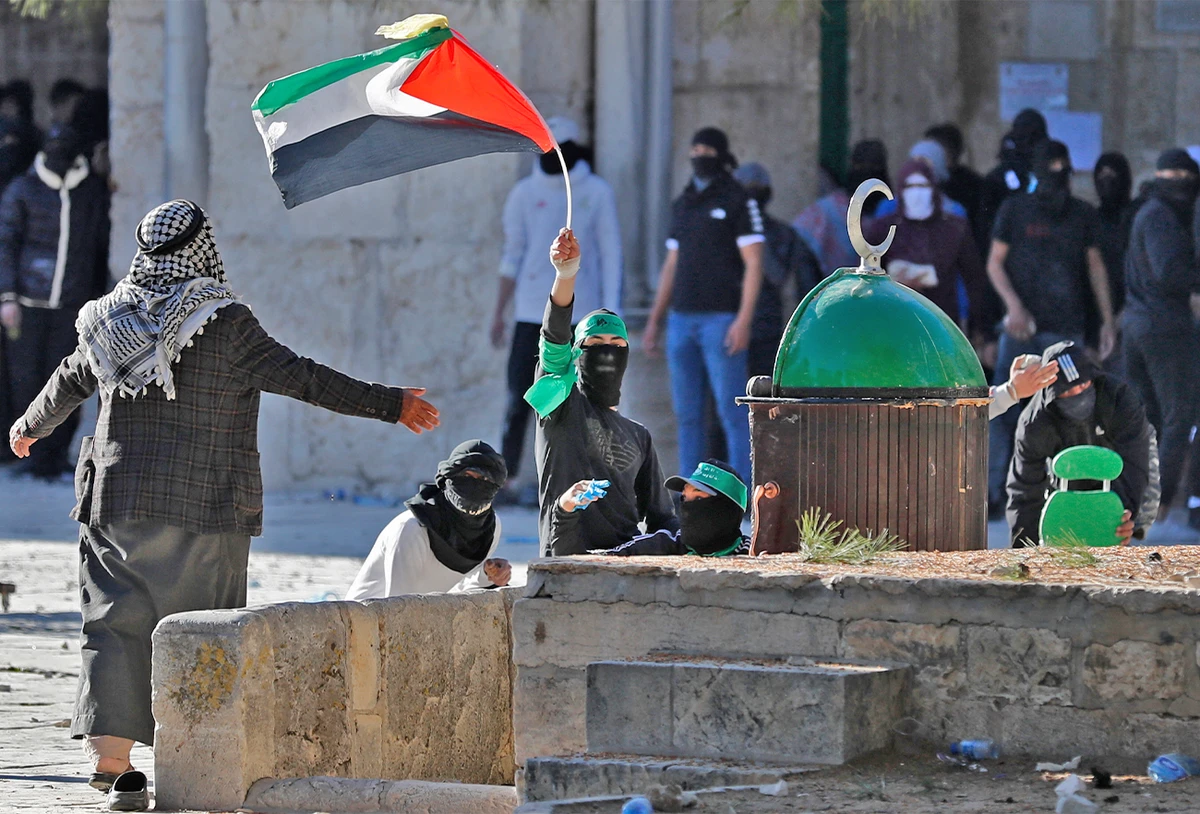 Palestinian demonstrators clash with Israeli police at Jerusalem's Al-Aqsa mosque compound on April 15, 2022. (AFP)