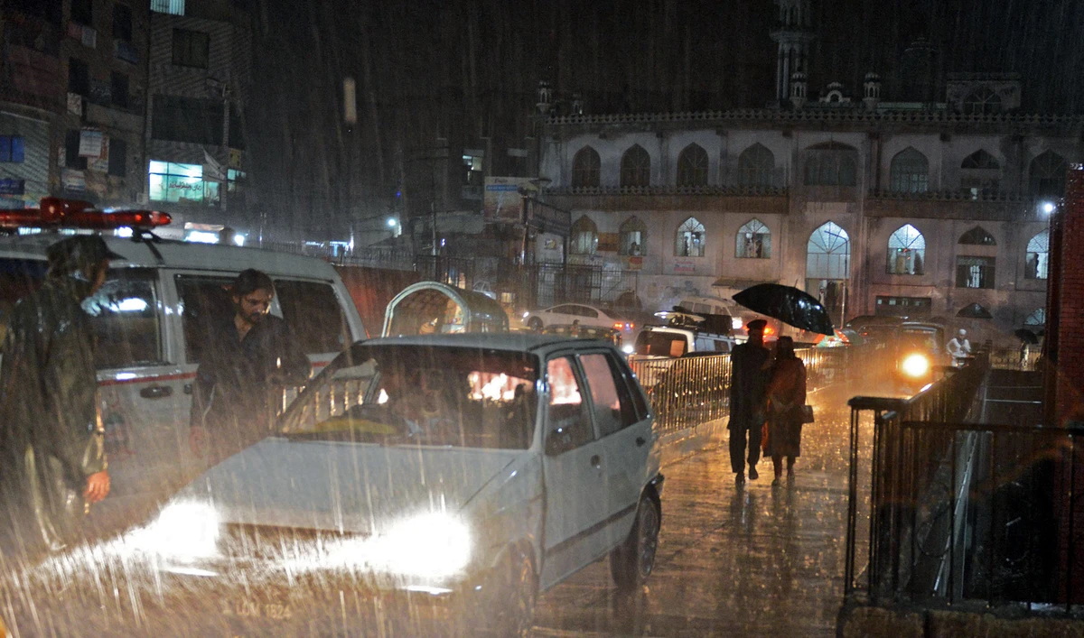 People drive their vehicles during heavy rain in Peshawar, Pakistan, on April 26, 2015. (AFP/File)