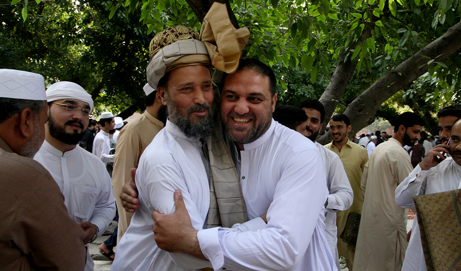 Muslims share Eid greetings after offering the Eid al-Fitr prayer, marking the end of Ramadan, Islam's holy month of fasting, in Peshawar, Pakistan, Monday, May 2, 2022. (AP)