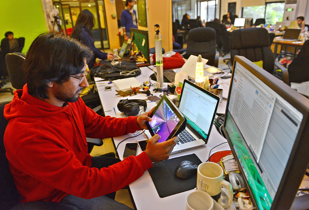 In this picture taken on January 21, 2014, Pakistani game designer Waqar Azim checks a designed game at his workplace in Islamabad. (AFP/File)