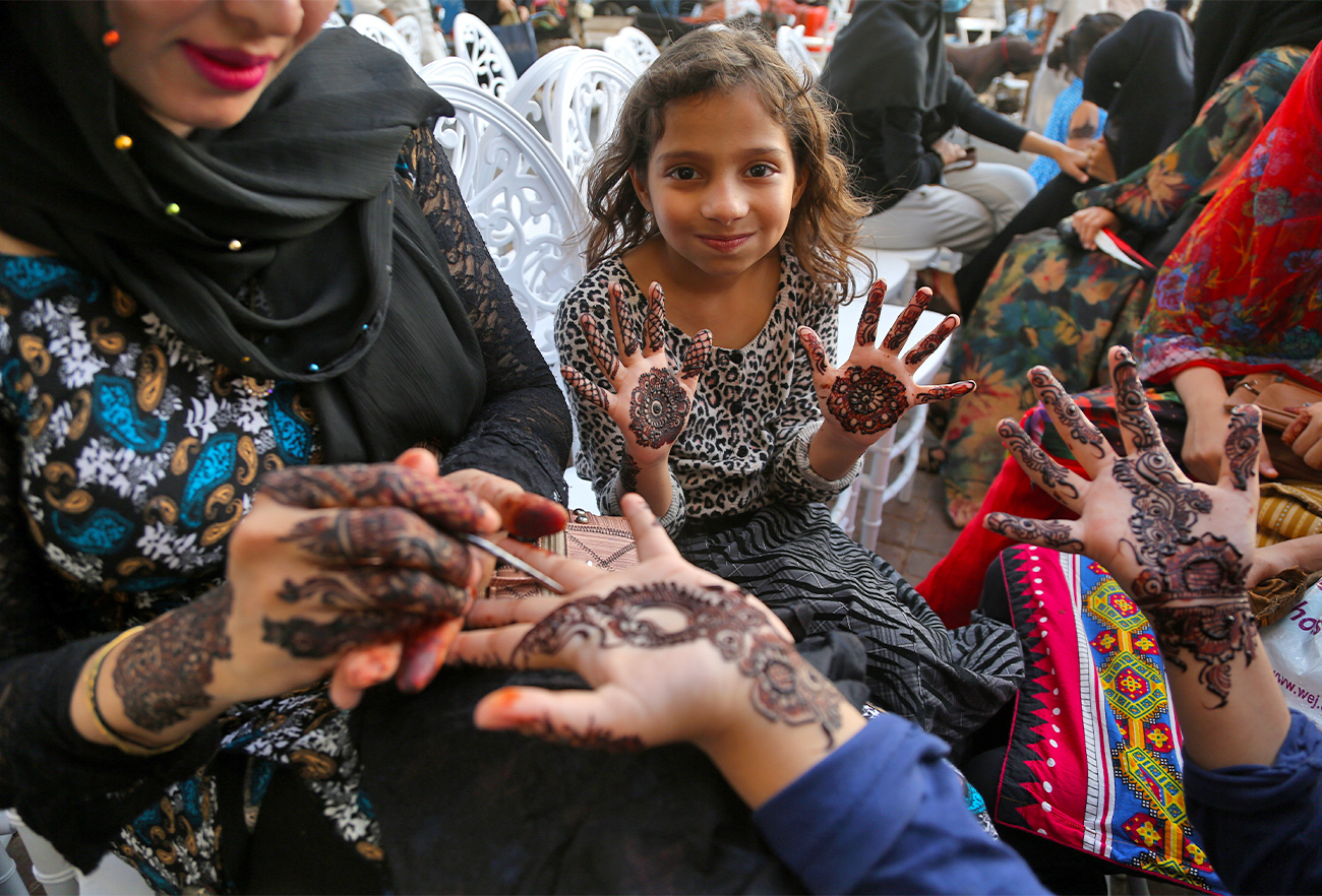 Girl shows the designs of mehndi (Urdu word for henna) on her hands at the Gulf Market in Karachi, Pakistan, on May 1, 2022. (AN Photo/S.A.Babar)