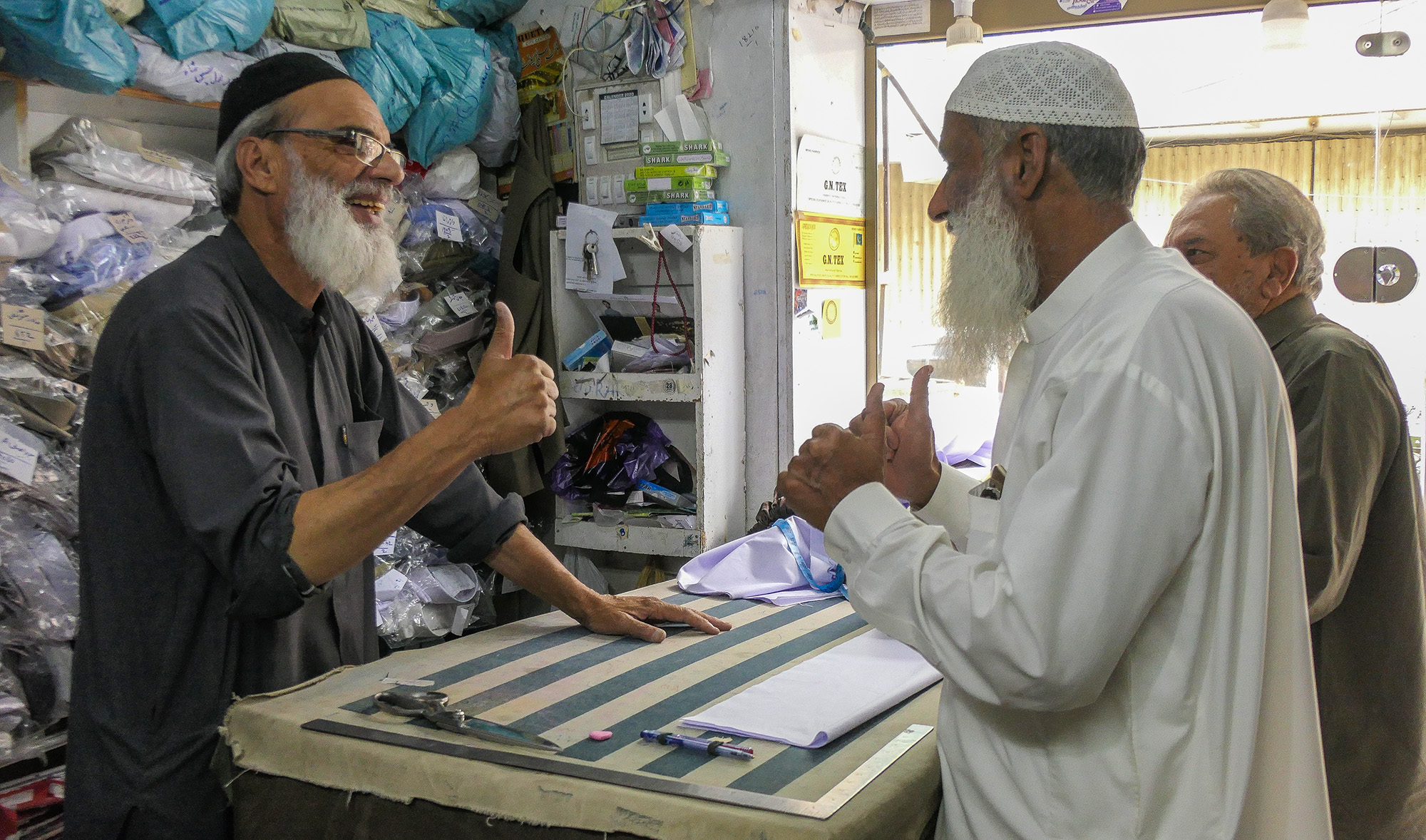 Deaf master tailor Haroon Razzaq communicates with customers at this shop in Yat Road, Quetta, Balochistan, southwestern Pakistan, on April 24, 2022. (AN photo)