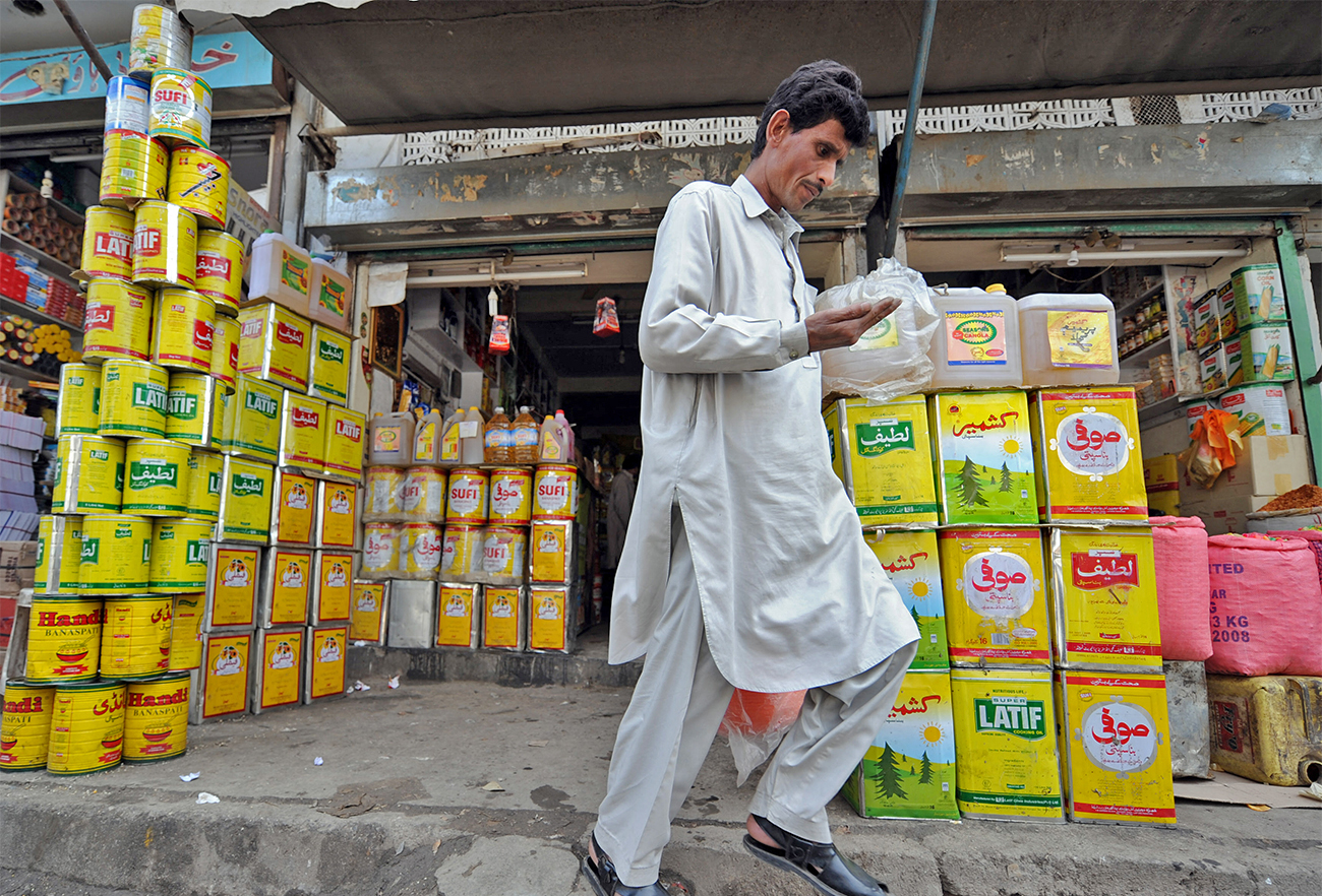 A Pakistani consumer comes out from the cooking oil shop in Rawalpindi, Pakistan, on April 6, 2008. (AFP/File)