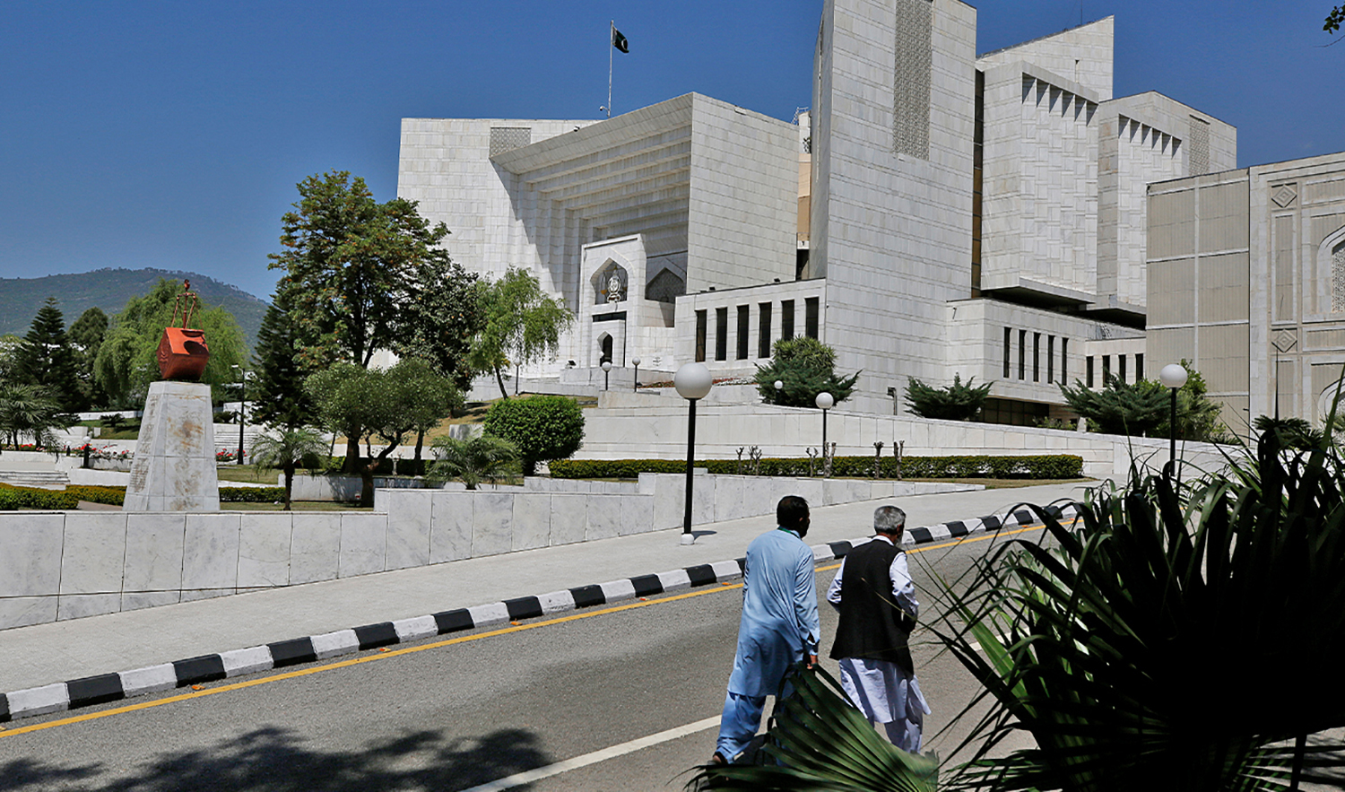 People walk past the Supreme Court in Islamabad, Pakistan, on April 4, 2022. (AP/File)