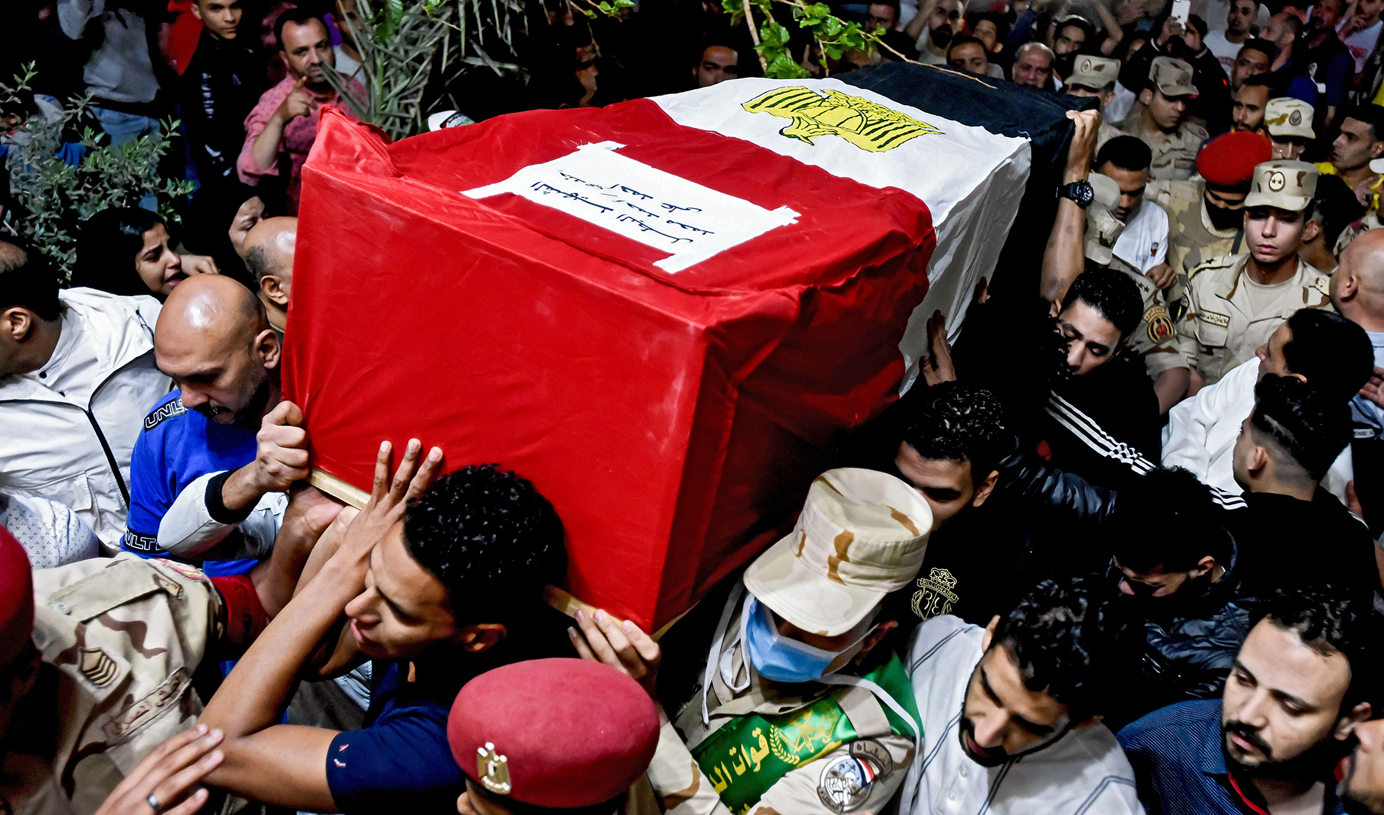 Men carry the coffin of military solider Ahmed Mohamed Ahmed Ali, who was killed in battle, during his funeral service, in Qalyubia province, Egypt on May 8, 2022. (AP)