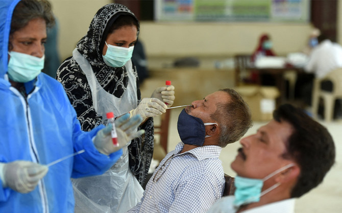 Health official collect swab samples from teachers to test for the coronavirus at a government school in Karachi, Pakistan, on September 14, 2020. (AFP/File)