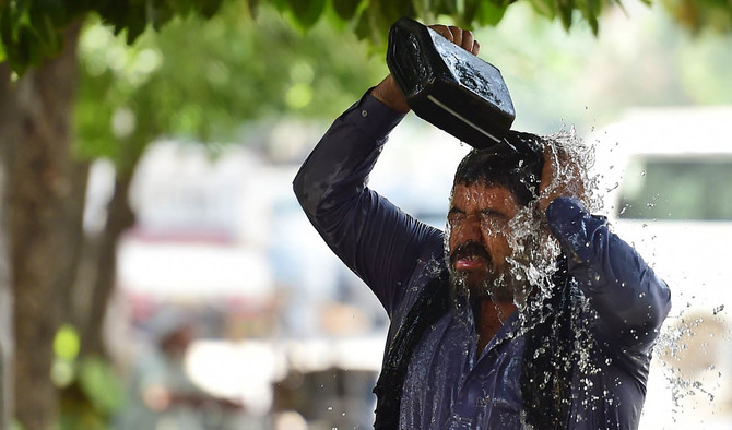 In this file photo, a Pakistani taxi driver showers himself with water on a hot summer day in Islamabad on May 29, 2018. (AFP)