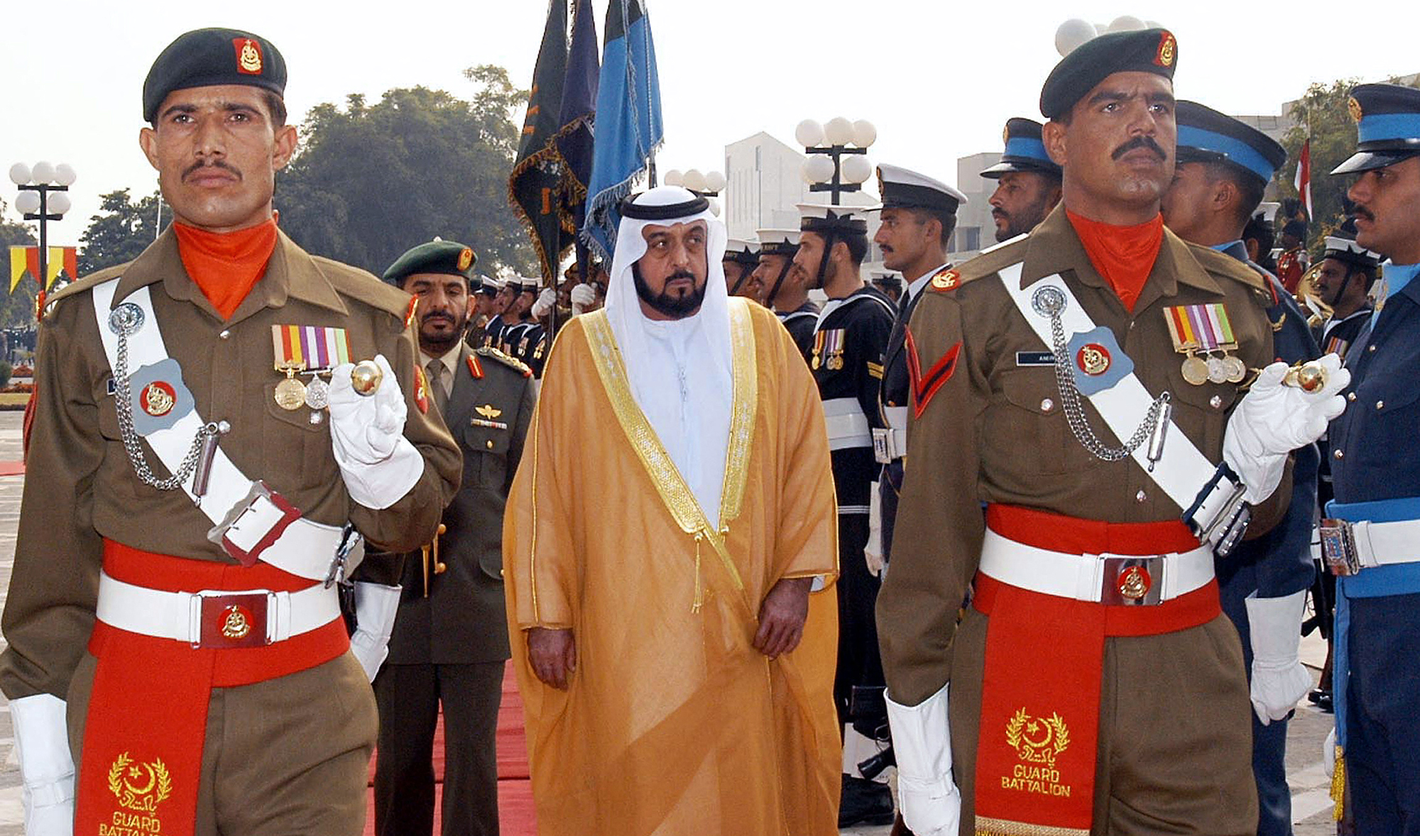 President of the United Arab Emirates (UAE) Sheikh Khalifa bin Zayed Al Nahyan, center, receives guard of honor upon his arrival in Islamabad, Pakistan, on December 27 2005. (AFP/File)