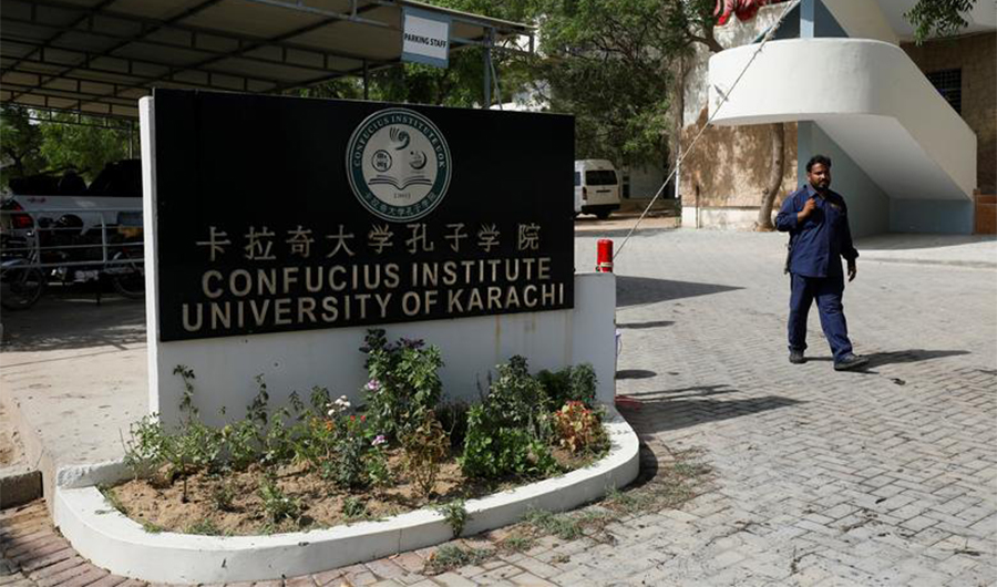 A security guard walks after a blast near a passenger van (not pictured) at the entrance of the Confucius Institute University of Karachi, Pakistan April 26, 2022. (REUTERS/FILE)