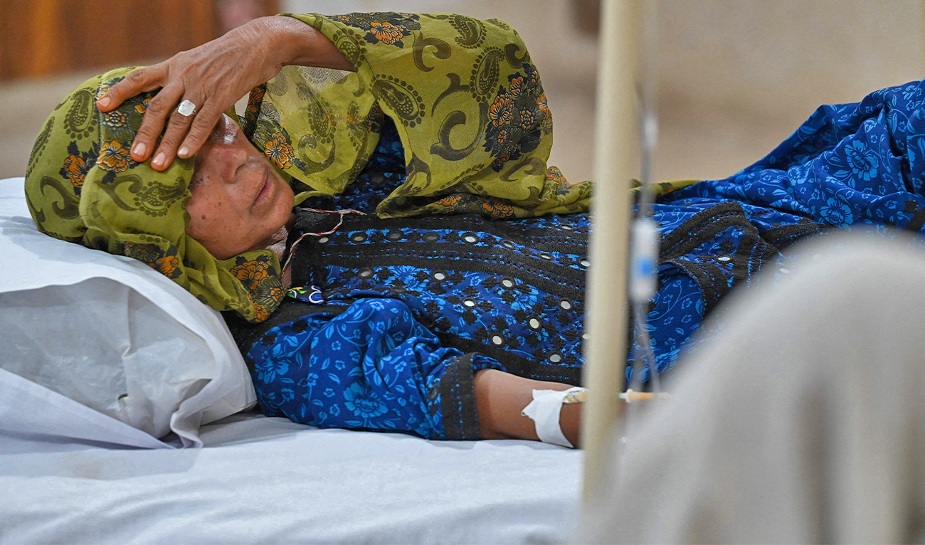 In this picture taken on May 11, 2022, a patient suffering from heat stroke is treated at a hospital in Jacobabad, in the southern Sindh province, Pakistan. (AFP)