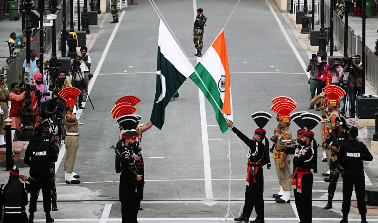 Pakistani Rangers and Indian Border Security Force (BSF) officers lower their national flags during a parade at Wagah border on August 14, 2018. (REUTERS/File)