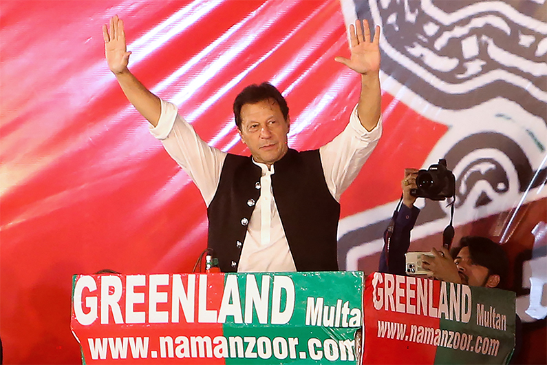 Former Pakistan Prime Minister Imran Khan gestures as he addresses supporters of the Pakistan Tehreek-e-Insaf (PTI) party during a rally in Multan on May 20, 2022. (AFP)