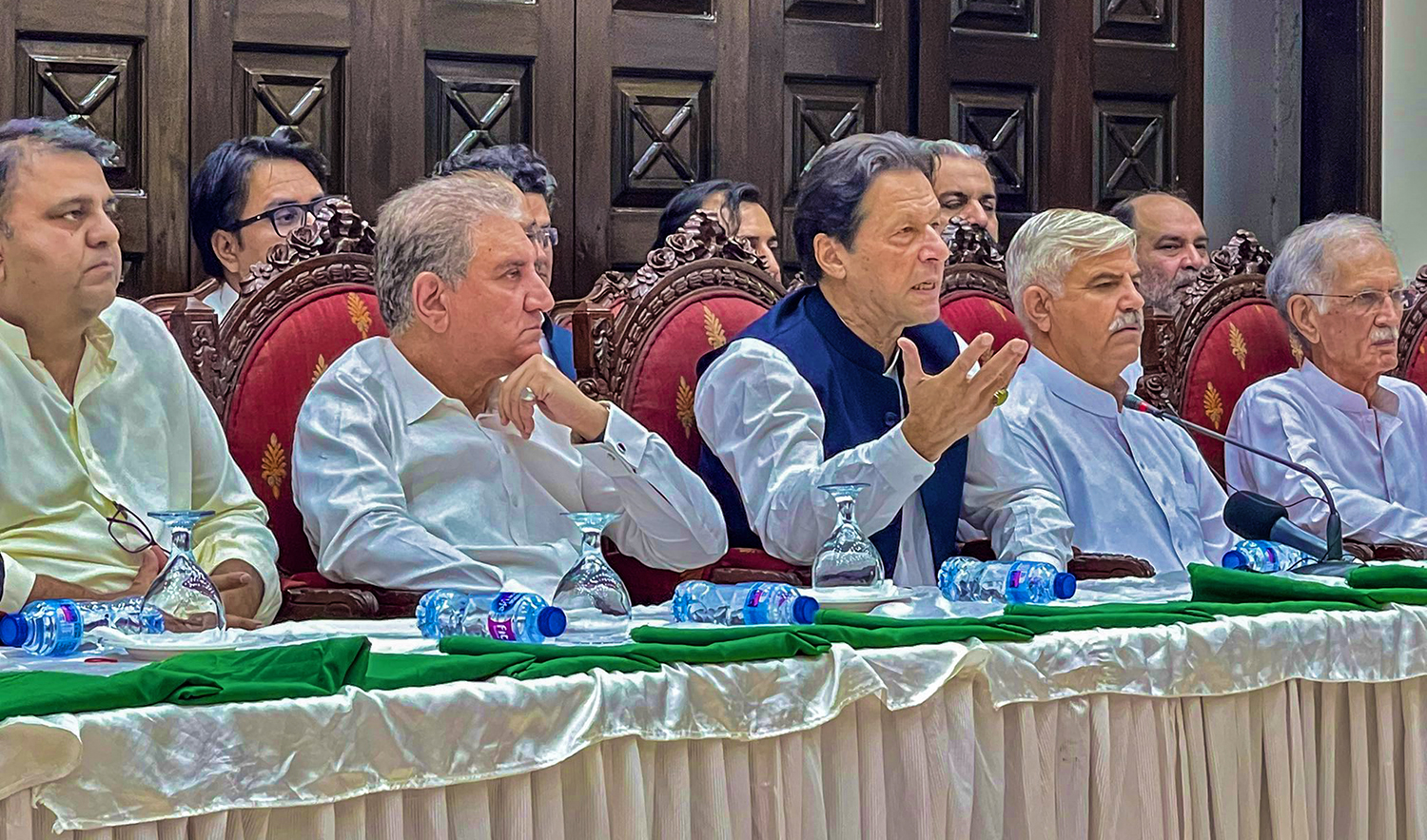 Pakistan Tehreek-e-Insaf (PTI) Chairman Imran Khan, center front, speaks during a press conference in Peshawar on May 22, 2022. (Photo courtesy: @PTIofficial/Twitter)