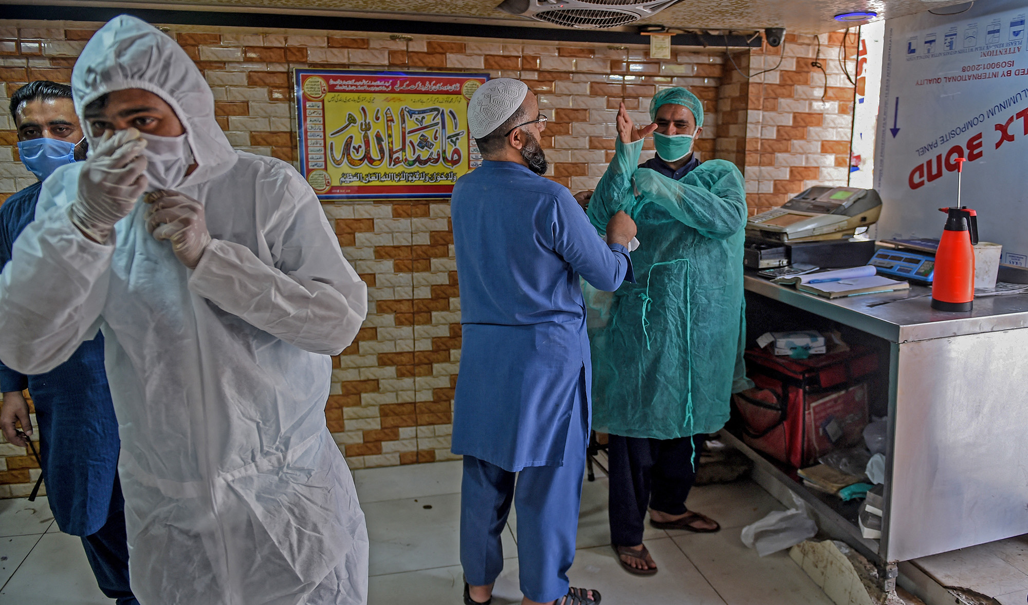 Employees wear protective gear at a restaurant open for takeaway and delivery services during a government-imposed nationwide lockdown as a preventive measure against the COVID-19, in Karachi on April 18, 2020. (AFP/File)