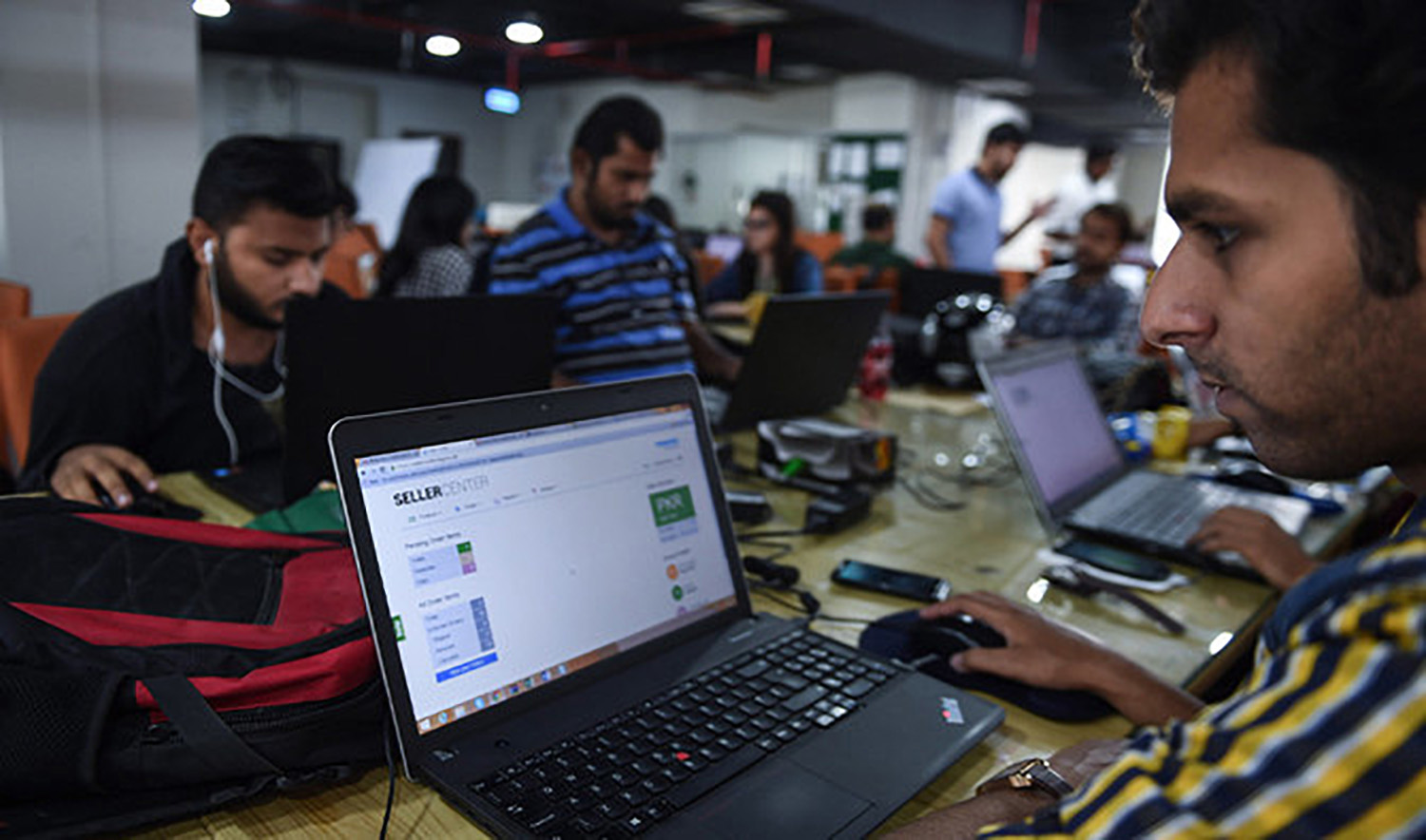 This photograph taken on November 19, 2015 shows Pakistani employees of online marketplace company at work in Karachi. (AFP/File)