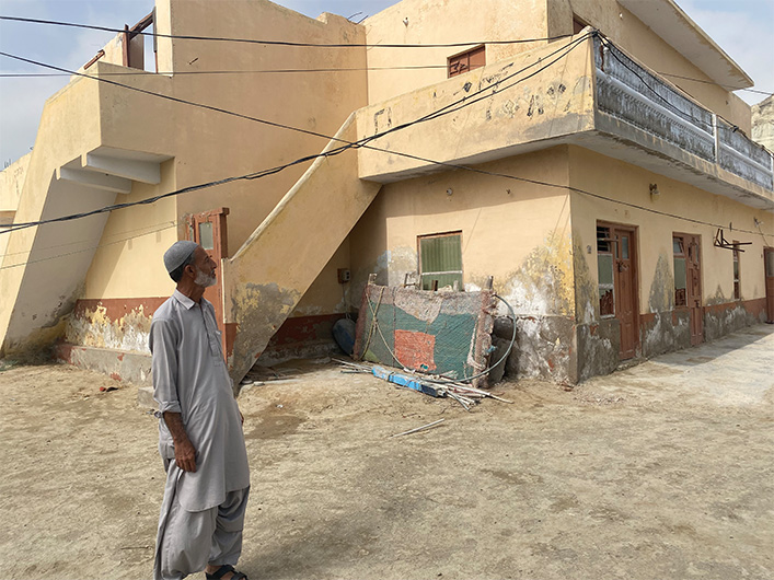 In this photo taken on May 20, 2022, Saleh Muhammad Sajid, a former cinema operator, looks at the building of Taj Mahal Talkies in Gwadar, Pakistan, where he once played Pakistani blockbusters. (AN Photo)