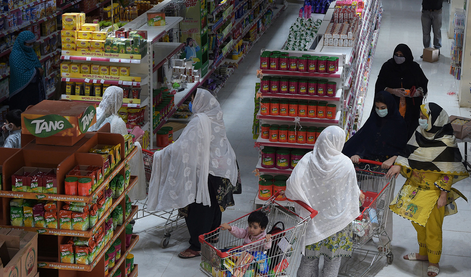 Resident wearing facemasks buy food items at a departmental store in Peshawar, Pakistan, on April 21, 2020. (AFP/File)