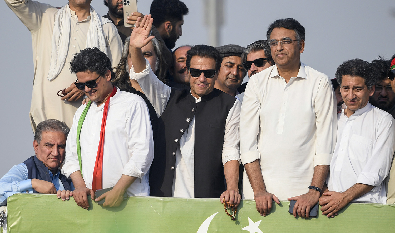 Pakistan's former prime minister Imran Khan, center, waves at his party supporters during a rally in Islamabad on May 26, 2022. (AFP)