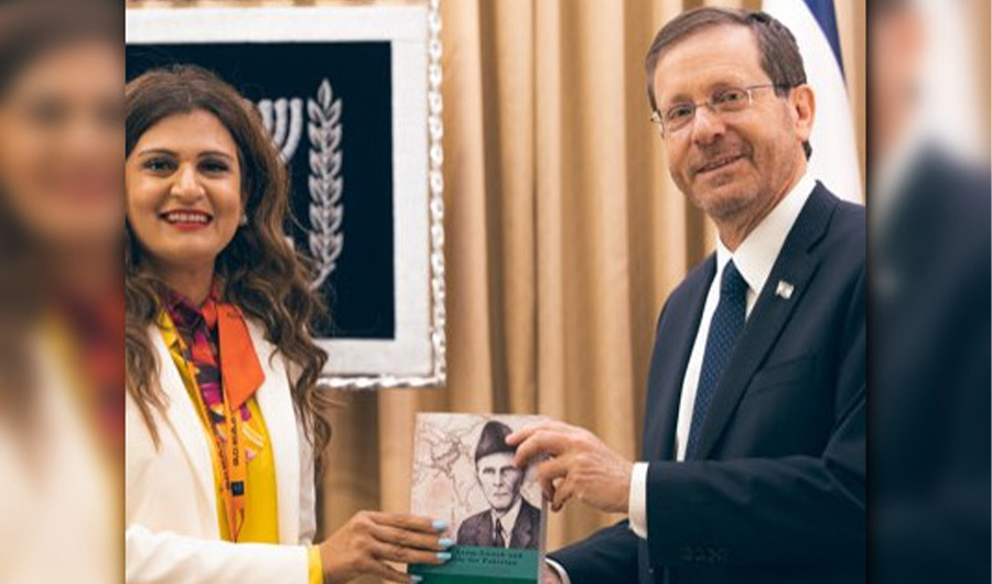 Anila Ali, Pakistani American (L) presenting a book to Israel's President Isaac Herzog in Jerusalem on May 19, 2022. (@anilaali/Twitter)