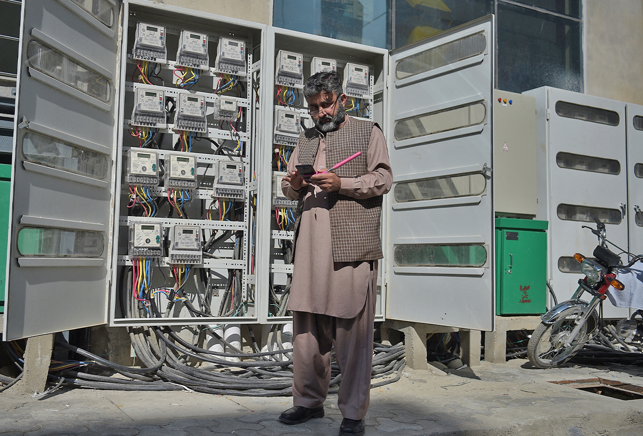 A Pakistani employee of the state-run Islamabad Electric Supply Company (IESCO), takes a meter reading with his smartphone at a commercial building in Islamabad, Pakistan, on November 7, 2018.(AFP/File)