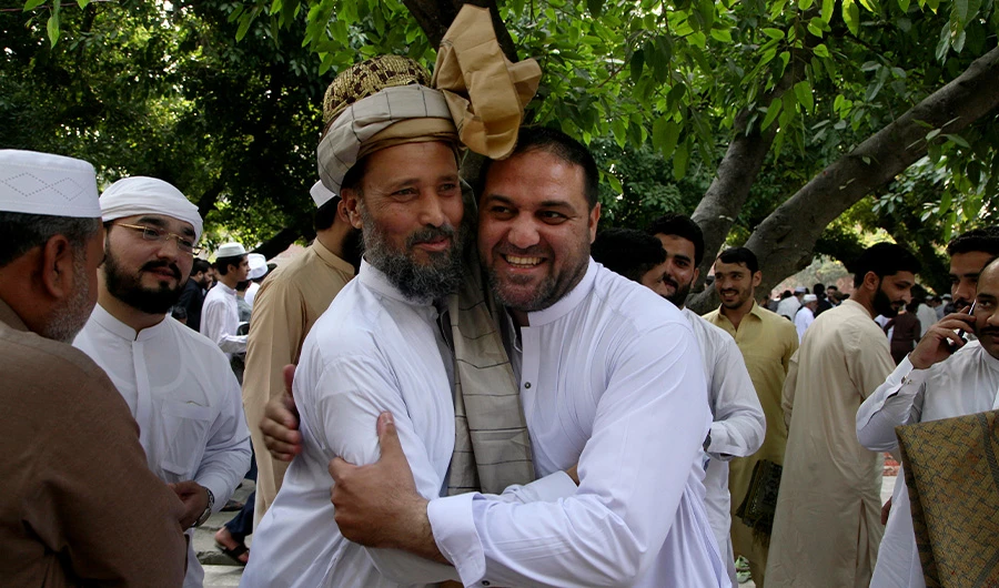 Muslims share Eid greetings after offering the Eid al-Fitr prayer, marking the end of Ramadan, Islam's holy month of fasting, in Peshawar, Pakistan, Monday, May 2, 2022. (AP)