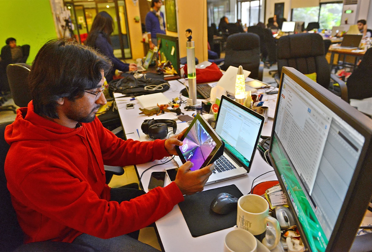 In this picture taken on January 21, 2014, Pakistani game designer Waqar Azim checks a designed game at his workplace in Islamabad. (AFP/File)