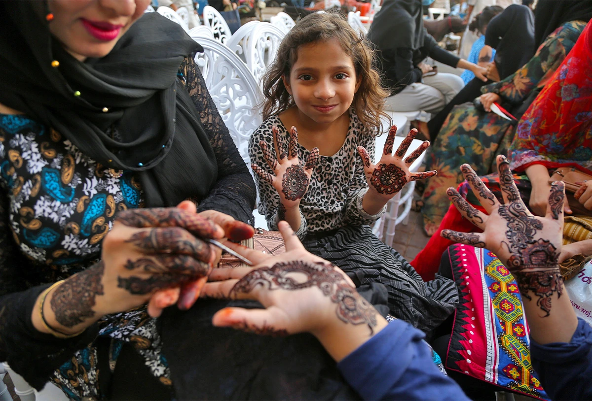 Girl shows the designs of mehndi (Urdu word for henna) on her hands at the Gulf Market in Karachi, Pakistan, on May 1, 2022. (AN Photo/S.A.Babar)