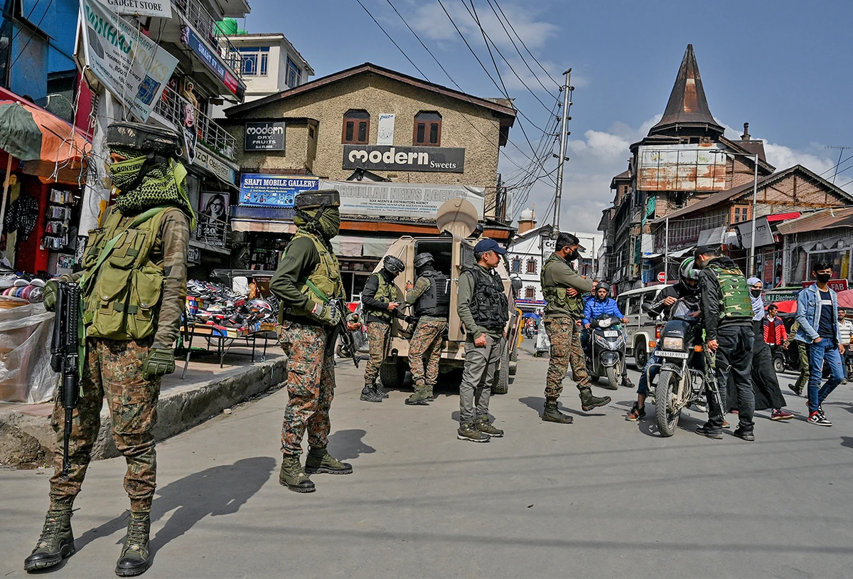 Paramilitary troopers stand guard during a random search operation at a market area in Srinagar on April 22, 2022. (AFP/File)