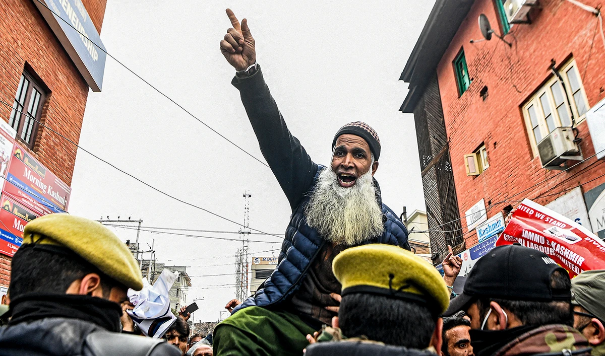 Laborers chant slogans while police try to stop them as they protest to demand the regularizations of their jobs in Srinagar on March 2, 2022. (AFP/File)