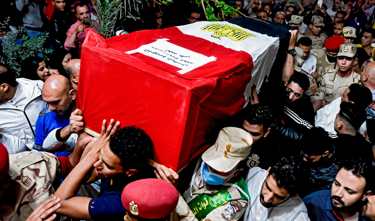 Men carry the coffin of military solider Ahmed Mohamed Ahmed Ali, who was killed in battle, during his funeral service, in Qalyubia province, Egypt on May 8, 2022. (AP)