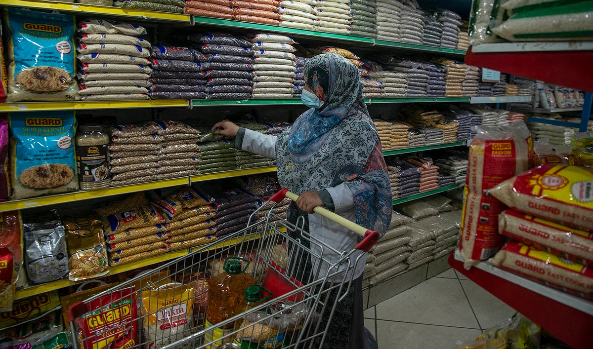 A woman buys grocery items at a store in Peshawar, Pakistan, on April 5, 2021. (AFP/File)