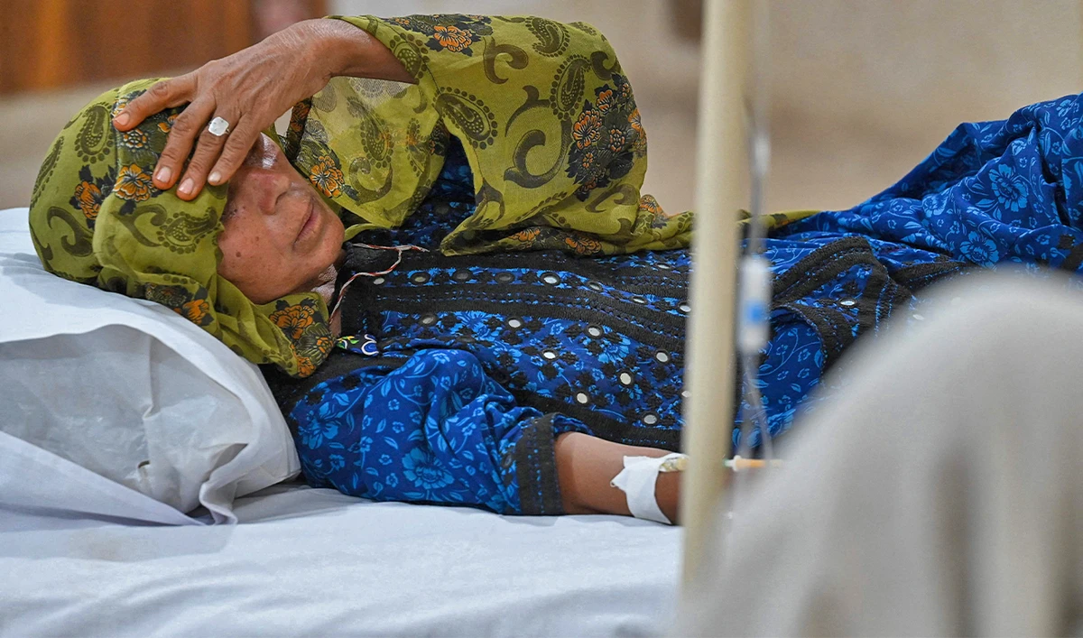 In this picture taken on May 11, 2022, a patient suffering from heat stroke is treated at a hospital in Jacobabad, in the southern Sindh province, Pakistan. (AFP)