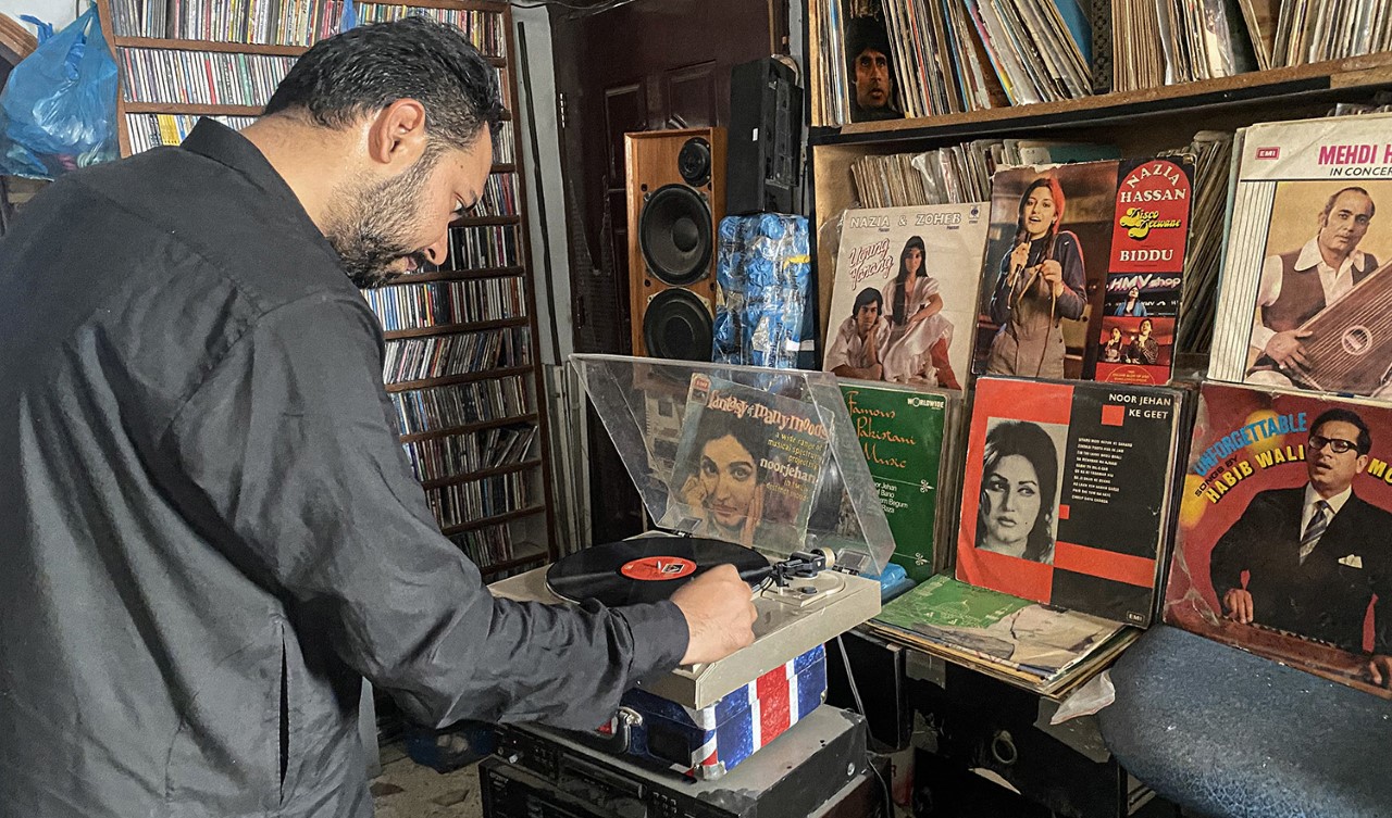 Muhammad Hussain plays a vinyl record at his music library in Karachi, Pakistan, on May 25, 2022. (AN photo)