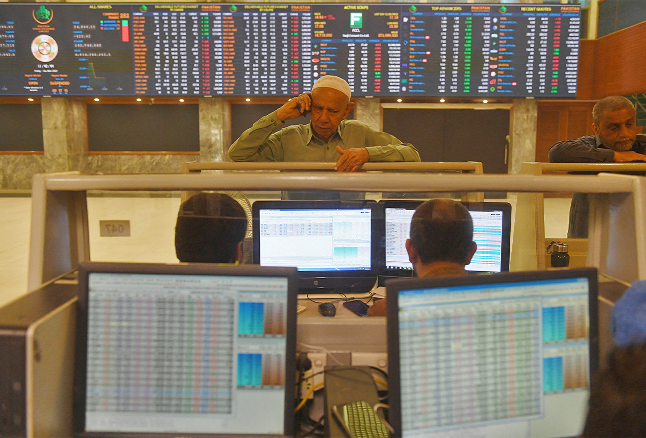 Stockbrokers monitor share prices at the Pakistan Stock Exchange in Karachi, Pakistan, on March 13, 2020. (AFP/File)