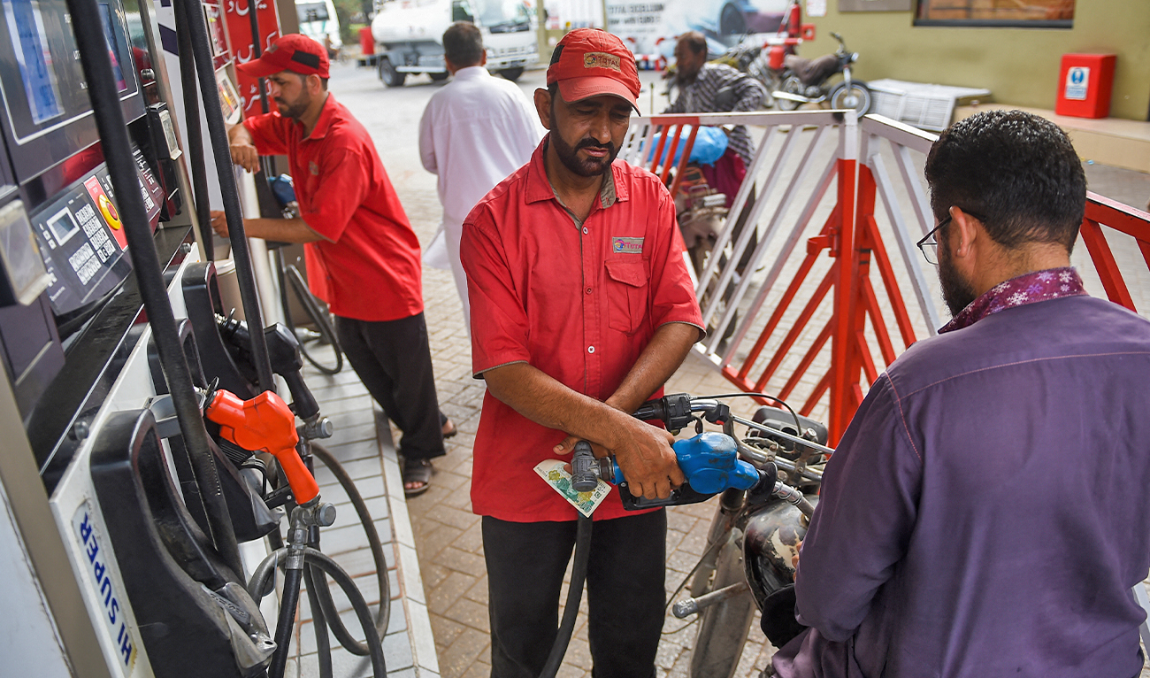 An employee fills a motorcycle at a service station in Karachi, Pakistan, on May 27, 2022. (AFP/File)