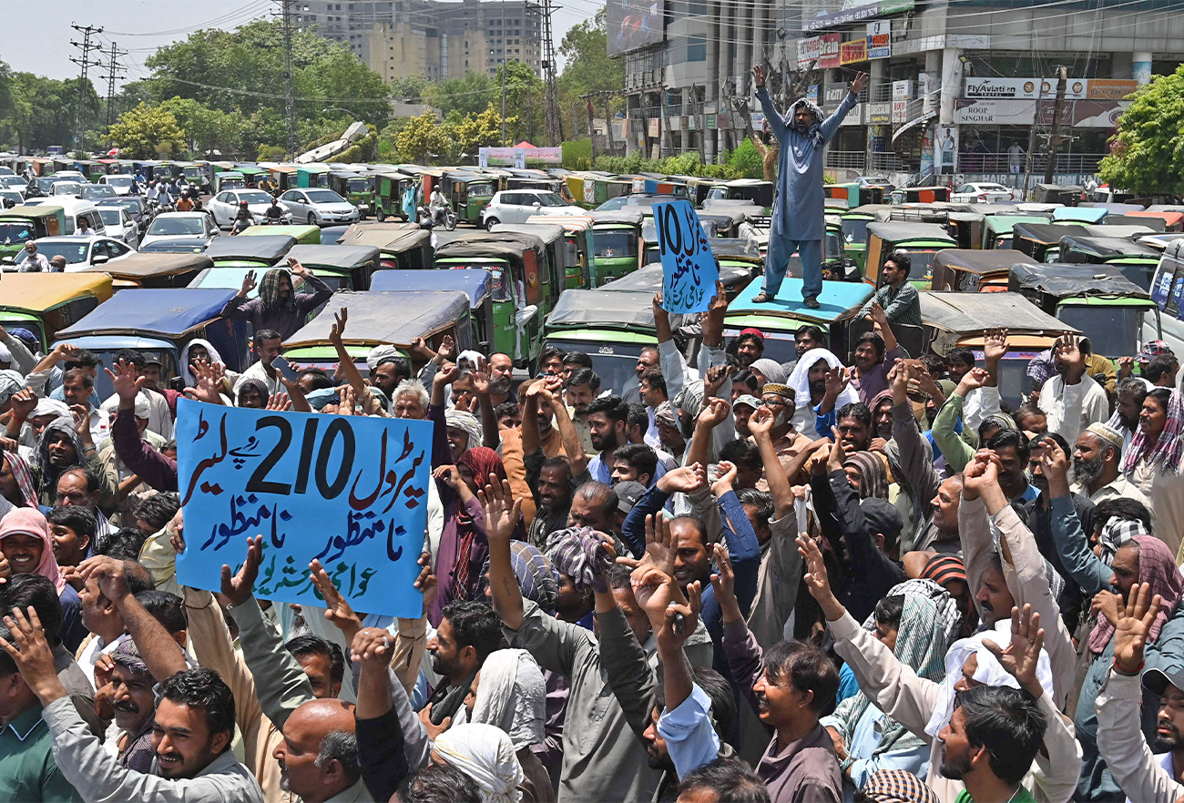 Auto rickshaw drivers shout slogans during an anti-government demonstration to a protest against the inflation and fuel price hike in Lahore, Pakistan, on June 3, 2022. (AFP)