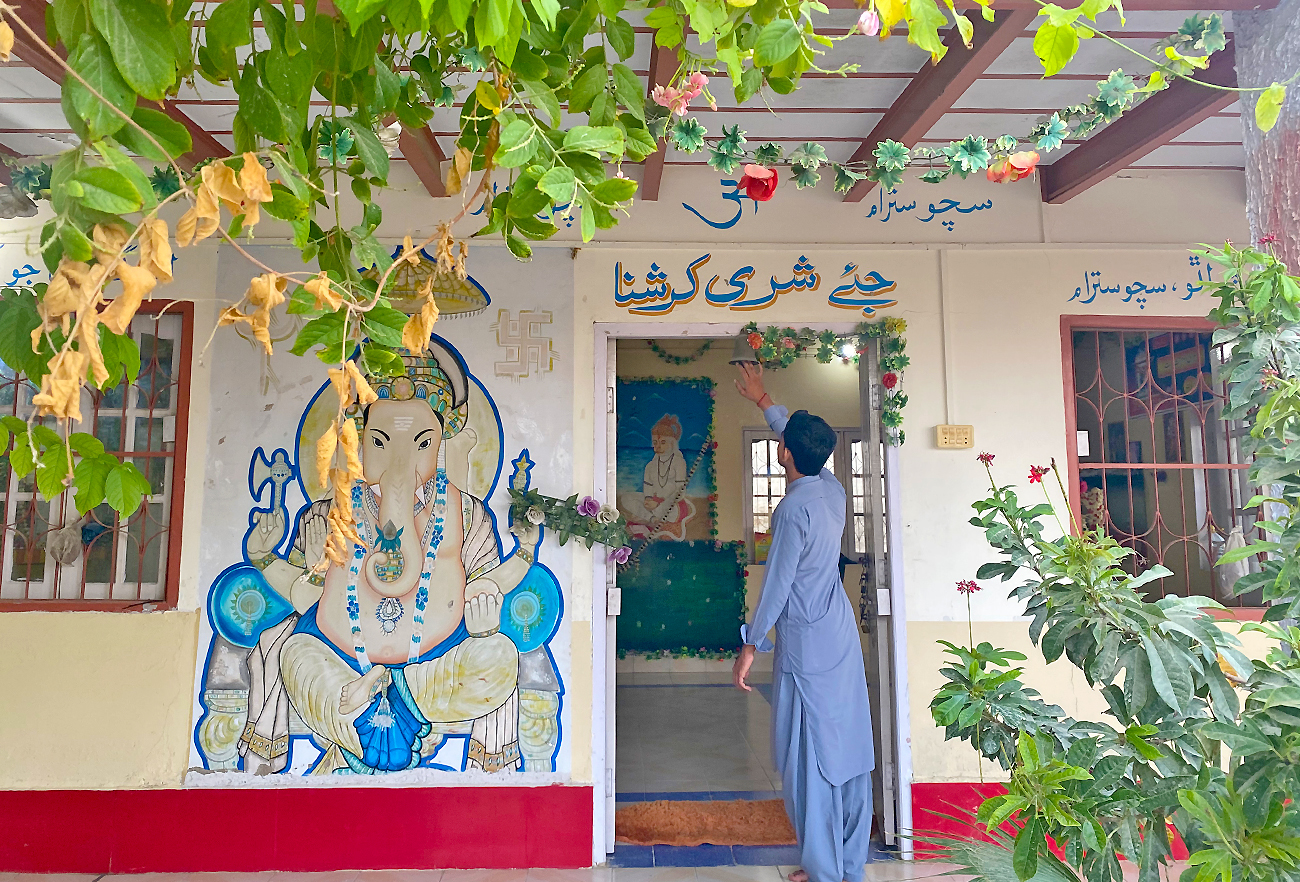 Shri Krishna Mandir caretaker's son Govid Kumar enters the temple in Shahi Bazar, Gwadar, Pakistan on May 19, 2022. (AN Photo)