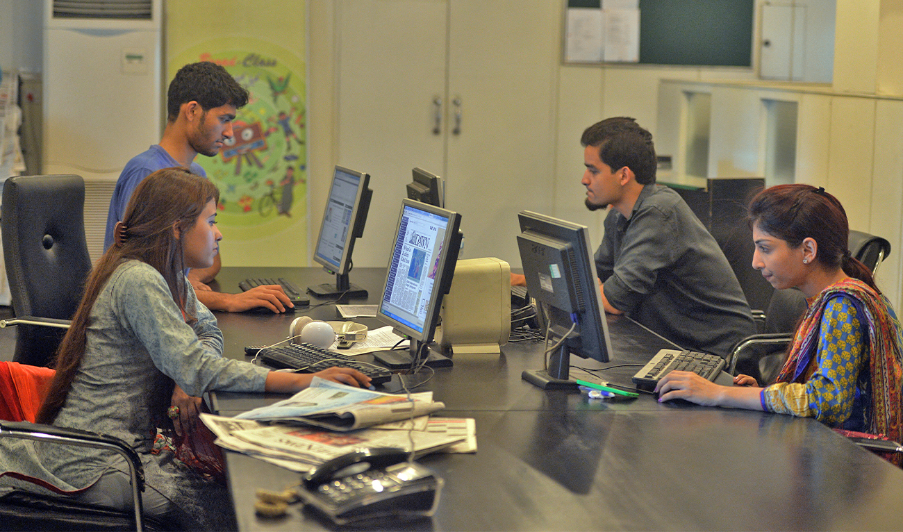In this photograph taken on July 26, 2016, Pakistani staff of Islamabad-based Power 99 FM radio work on their computers at the radio station's office in Islamabad. (AFP/File)