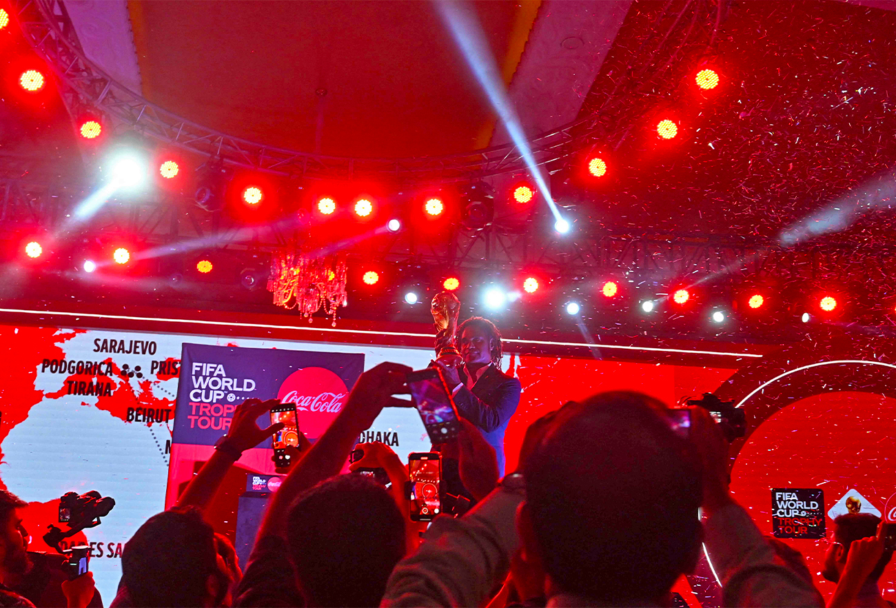 French former football player Christian Karembeu poses with the FIFA World Cup trophy during a ceremony in Lahore, Pakistan, on June 7, 2022. (AFP)