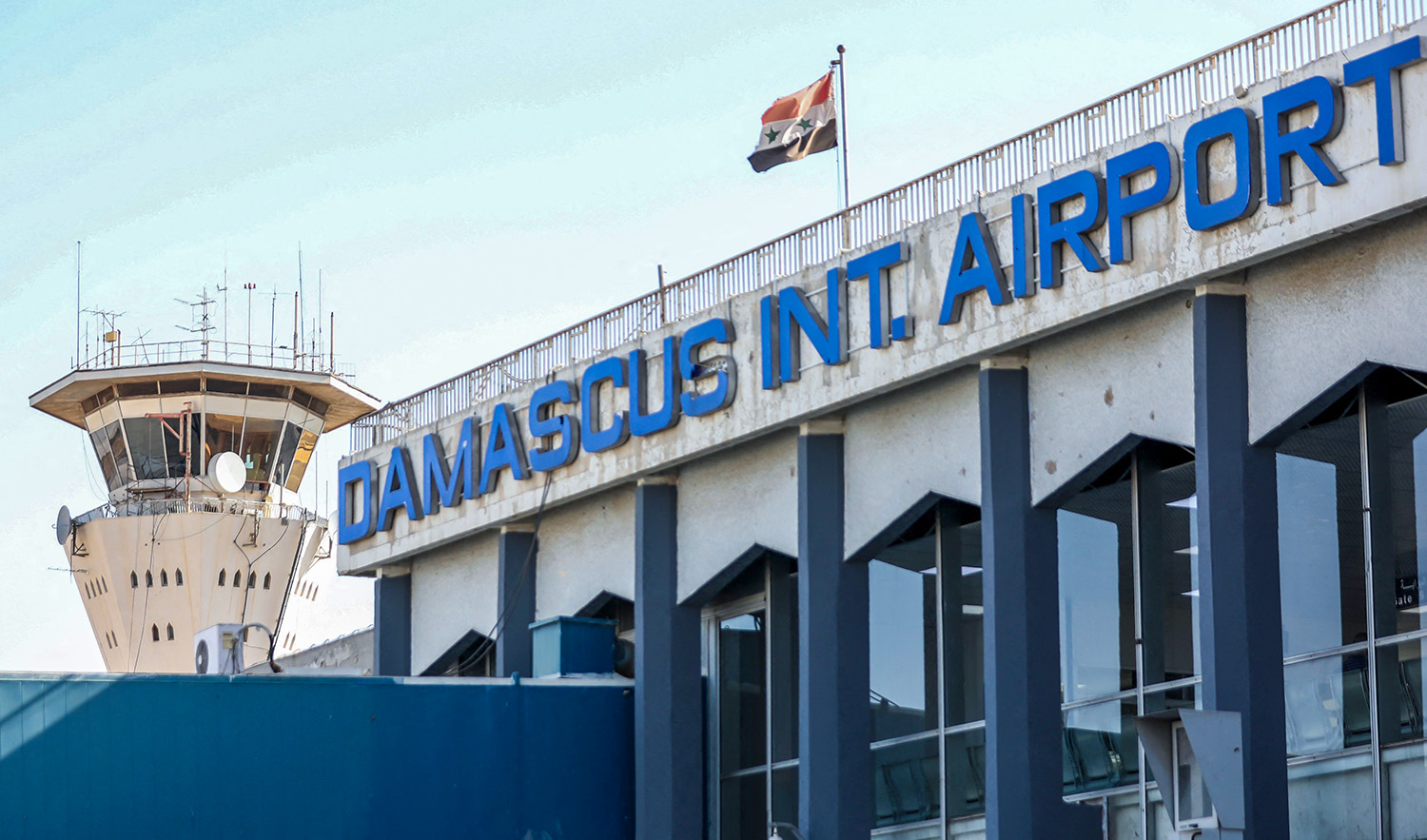 This file photo taken on October 1, 2020 shows the Syrian flag flying at Damascus International Airport outside Syria's capital. (AFP/File)