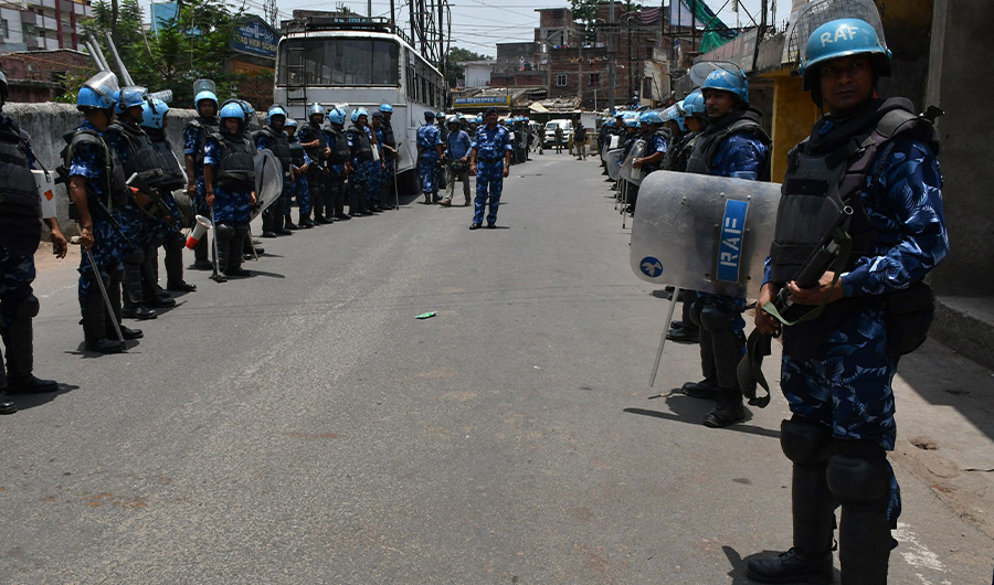 Rapid Action Force personnel stand guard along a road during a partial curfew imposed following demonstrations against former spokeswoman Nupur Sharma's remarks on the Prophet Mohammed (PBUH), in Ranchi on June 11, 2022. (AFP)