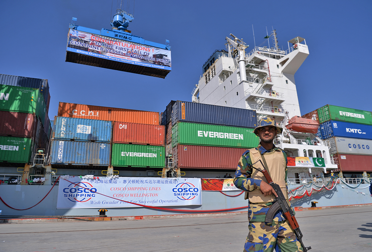 A Pakistani Naval personnel stands guard beside a ship carrying containers during the opening of a trade project in Gwadar port, Pakistan, on November 13, 2016. (AFP/File)