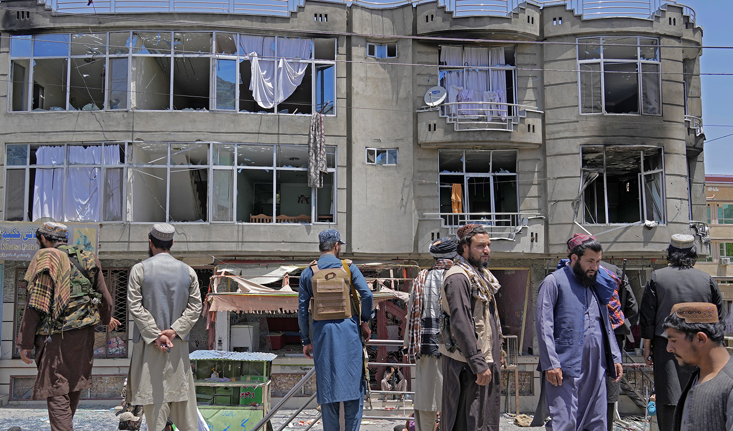 Taliban fighters stand guard at the site of an explosion in front of a Sikh temple in Kabul, Afghanistan, on June 18, 2022. (AP)