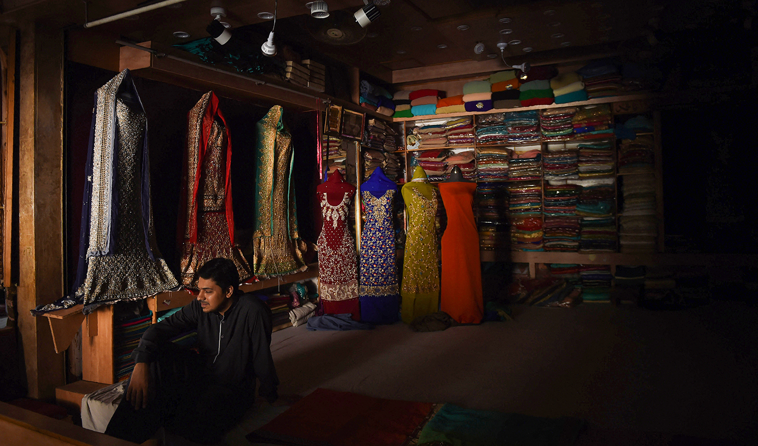Pakistan shopkeeper sits in his shop during a power cut in Karachi, Pakistan, on May 17, 2018. (AFP/File)