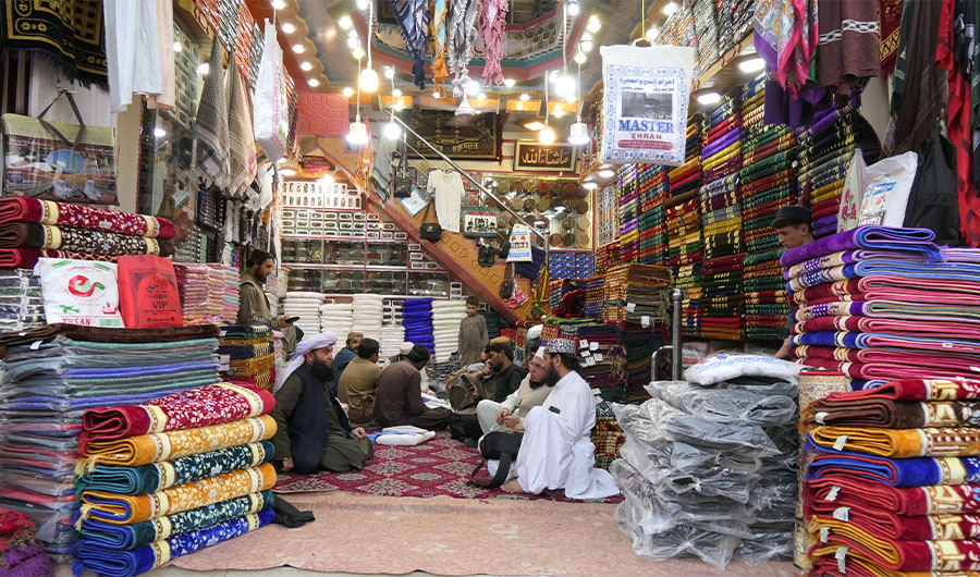 Pakistani Hajj pilgrims gather inside an Ihram clothing shop in Masjid Road in Quetta, Pakistan on June 16, 2022. (AN Photo)