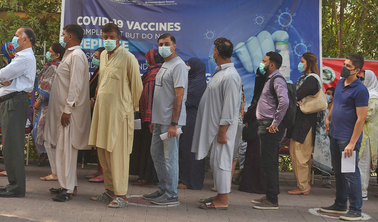 People wait in queue for their turn to receive a dose of the Sinopharm Covid-19 vaccine at a vaccination centre in Karachi, Pakistan, on May 5, 2021. (AFP/File)