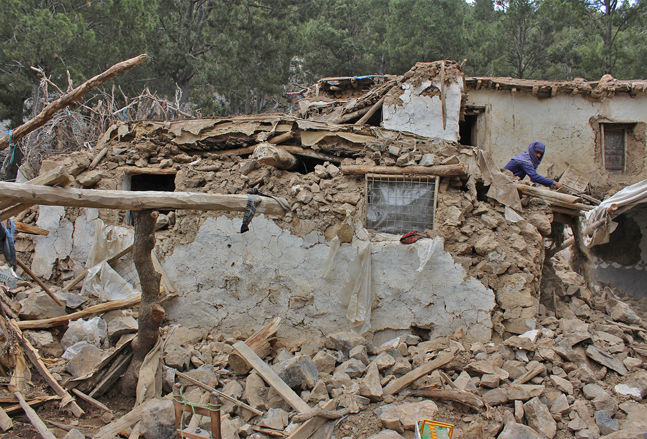 An Afghan villager collects his belongings from under the rubble of his home that was destroyed in an earthquake in the Spera District of the southwestern part of Khost Province, Afghanistan, on June 22, 2022. (AP)