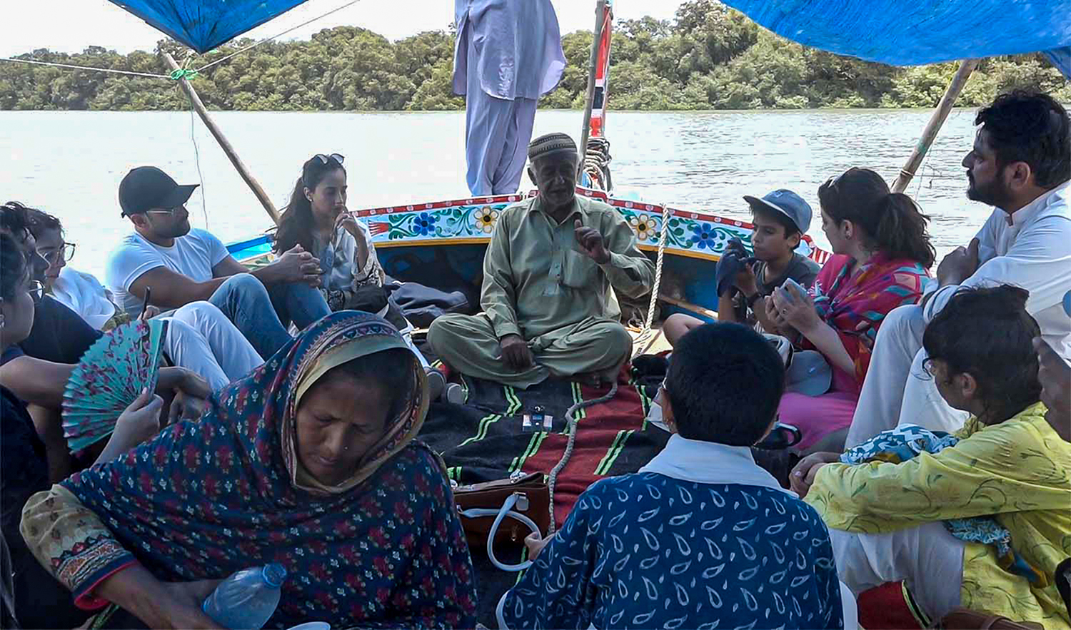 Abdul Majeed Motani, a 70-year-old fisherman, talks to a tour group on a fishing boat on Kuddi Island in the Arabian Sea off Karachi, Pakistan, on June 18, 2022. (AN photo)